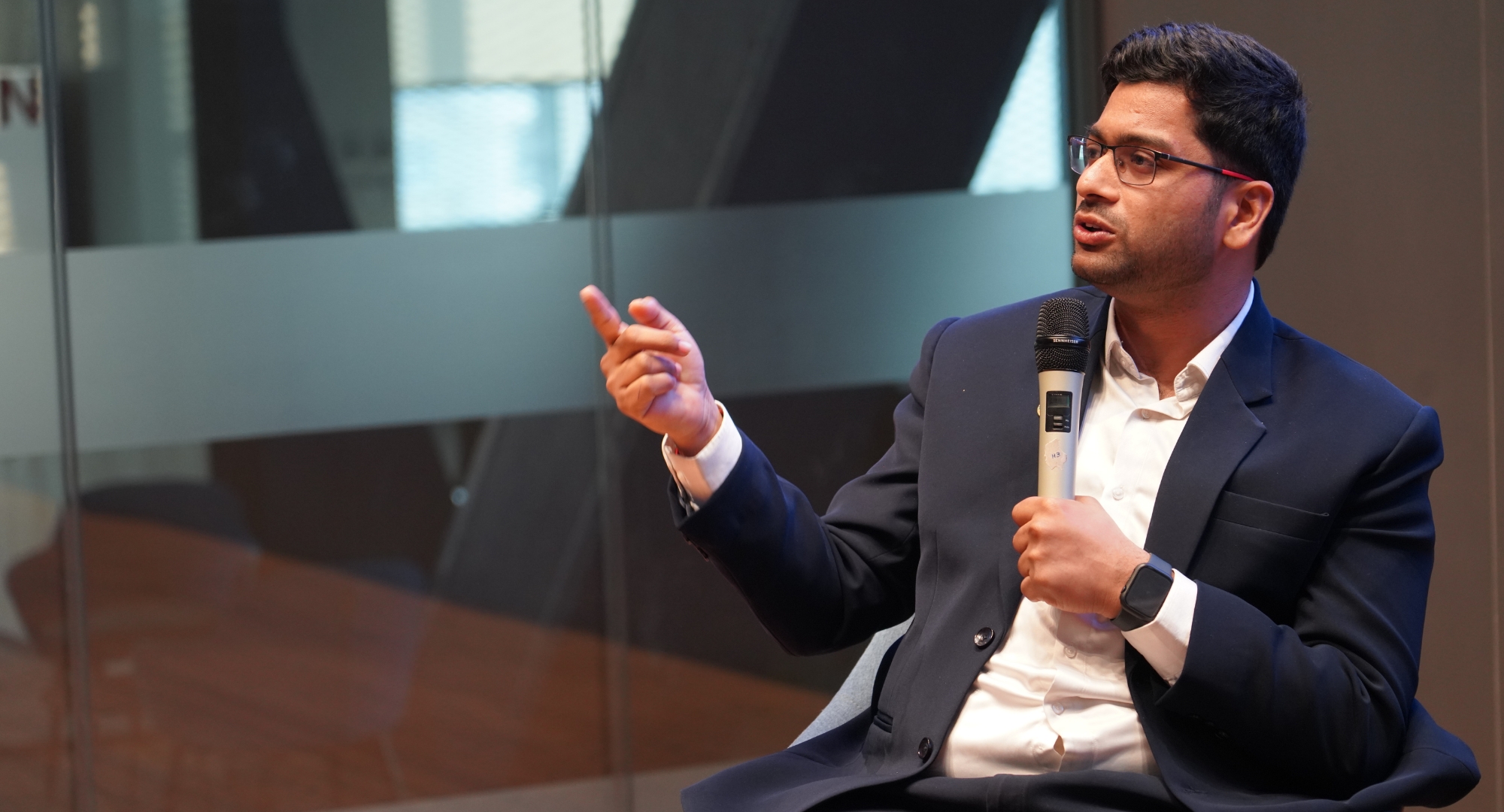 Nikeelu Gunda speaking with a microphone